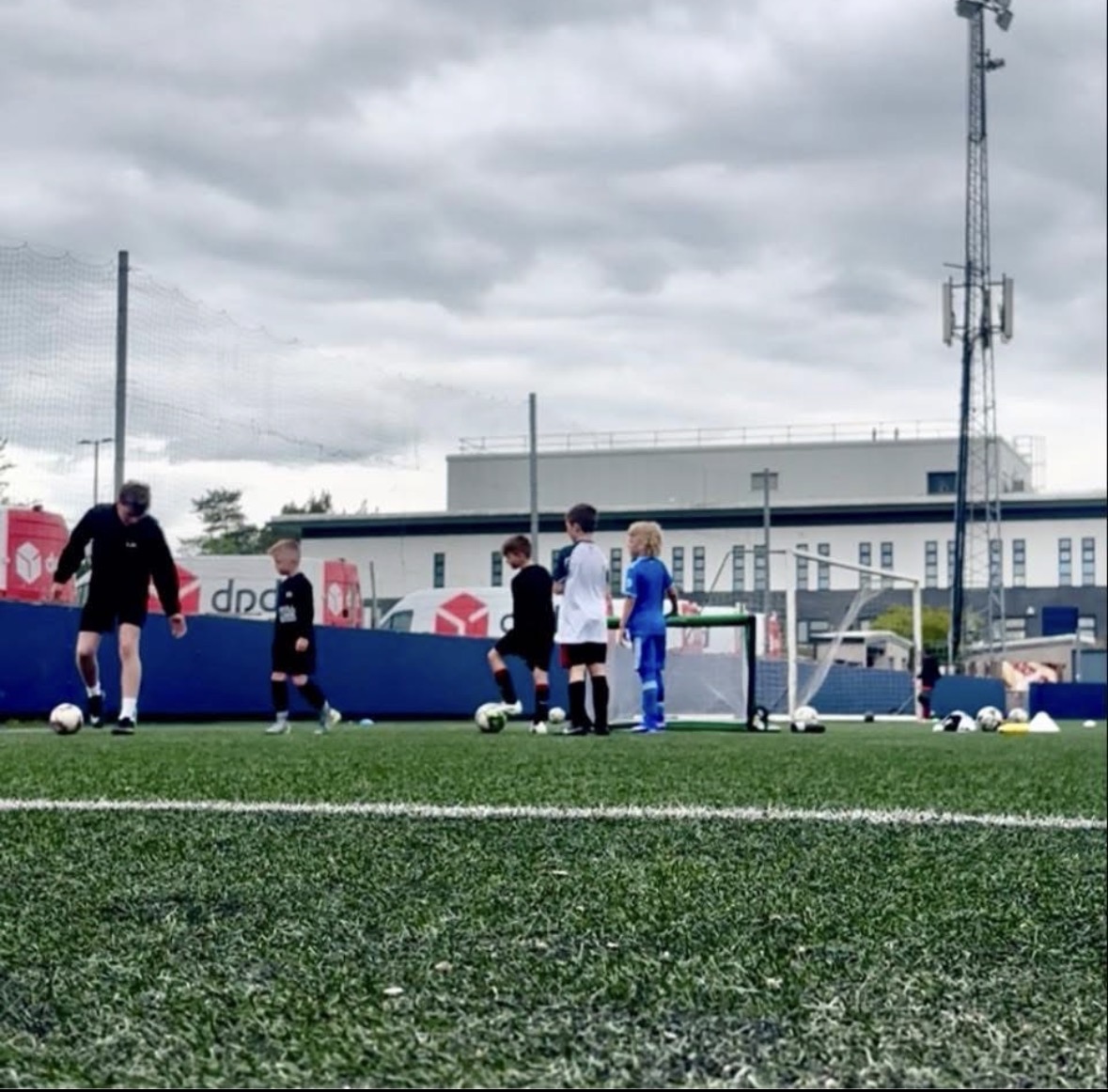 Coach Lawrence Nichol running a youth training session on a 3G pitch